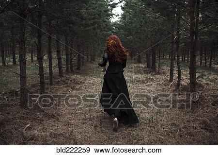 Caucasian woman walking on forest path View Large Photo Image Stock Photo - Caucasian woman walking on forest path. Fotosearch