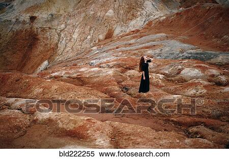 Stock Photography - Caucasian woman walking on rock formation. Fotosearch