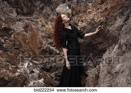 Caucasian woman walking on rocky hillside View Large Photo Image Picture - Caucasian woman walking on rocky hillside. Fotosearch