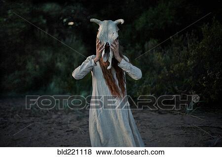 Caucasian woman wearing animal skull View Large Photo Image Stock Photo - Caucasian woman wearing animal skull. Fotosearch