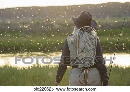 Caucasian woman wearing fishing gear in remote lake View Large Photo Image Stock Photography - Caucasian woman wearing fishing gear in remote lake. Fotosearch