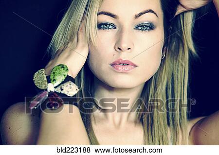 Stock Photo - Caucasian woman wearing flower bracelet. Fotosearch