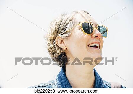 Caucasian woman wearing sunglasses outdoors View Large Photo Image Stock Image - Caucasian woman wearing sunglasses outdoors. Fotosearch