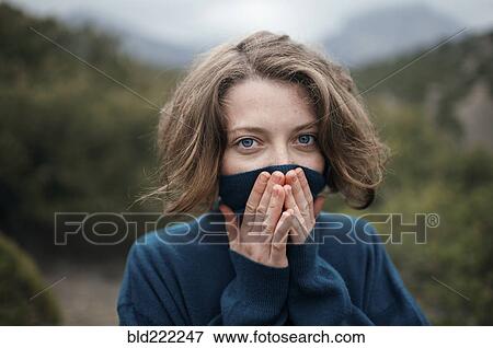Stock Photo - Caucasian woman wearing turtleneck sweater outdoors. Fotosearch