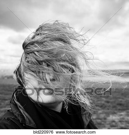 Stock Photograph - Caucasian woman with hair blowing in wind. Fotosearch