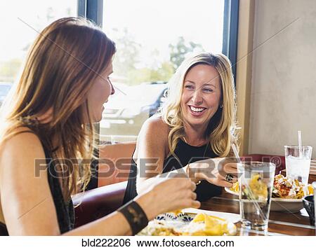 Caucasian women eating in cafe View Large Photo Image Stock Photograph - Caucasian women eating in cafe. Fotosearch