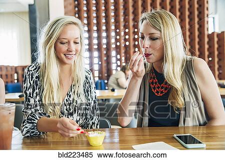 Caucasian women tasting dessert at bar View Large Photo Image Stock Photography - Caucasian women tasting dessert at bar. Fotosearch