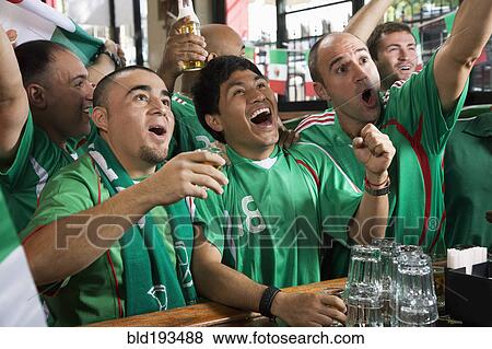 Stock Photo - Cheering men watching television in sports bar. Fotosearch