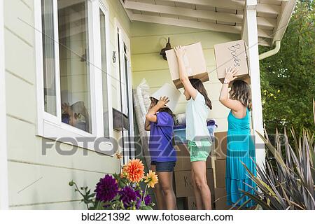 Children carrying cardboard boxes into house View Large Photo Image Stock Image - Children carrying cardboard boxes into house. Fotosearch