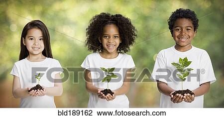Stock Image - Children holding seedlings. Fotosearch