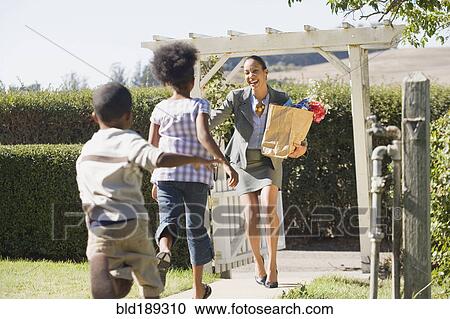 Children running to mother carry groceries View Large Photo Image Stock Image - Children running to mother carry groceries. Fotosearch