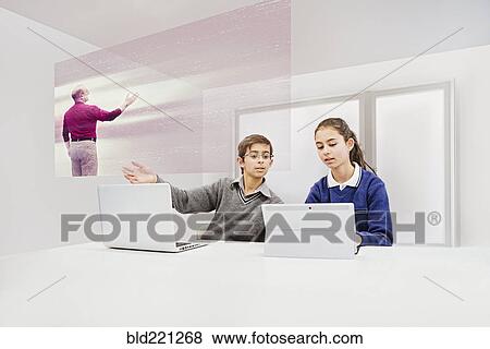 Stock Photo - Children watching floating screen in online class. Fotosearch