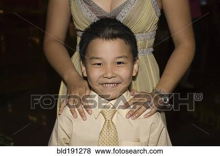 Stock Photo - Chinese boy standing with mother. Fotosearch