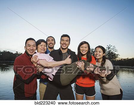 Chinese family posing near lake outdoors View Large Photo Image Stock Image - Chinese family posing near lake outdoors. Fotosearch