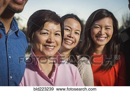 Chinese family smiling outdoors View Large Photo Image Stock Photo - Chinese family smiling outdoors. Fotosearch
