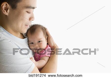 Picture - Chinese father holding baby daughter. Fotosearch