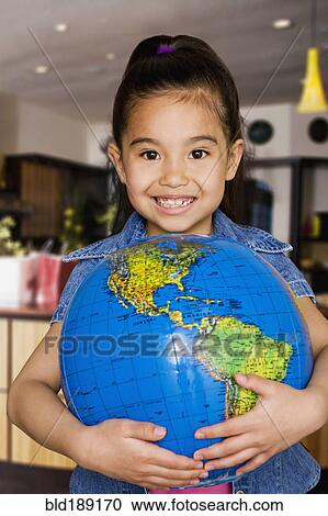 Stock Image - Chinese girl holding globe. Fotosearch