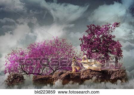 Stock Photo - Chinese woman holding fabric in fog on windy rock. Fotosearch