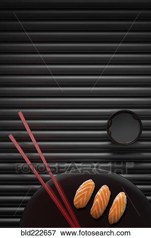 Chopsticks and sushi on round plate with dipping sauce View Large Photo Image Stock Photo - Chopsticks and sushi on round plate with dipping sauce. Fotosearch