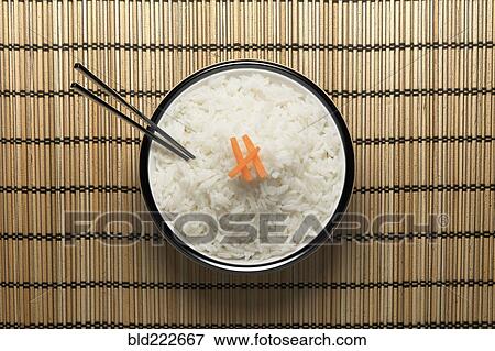 Stock Photo - Chopsticks in bowl of white rice. Fotosearch
