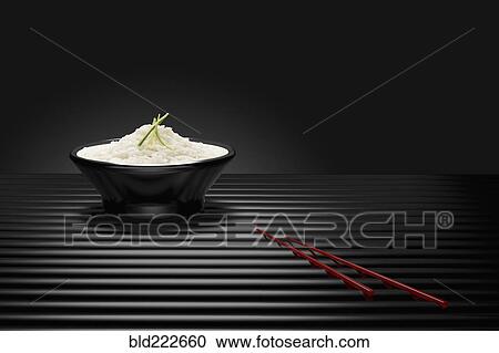 Chopsticks near bowl of white rice View Large Photo Image Stock Image - Chopsticks near bowl of white rice. Fotosearch