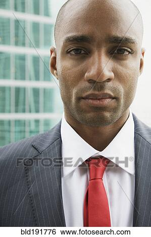 Close up of African businessman looking serious View Large Photo Image Stock Photograph - Close up of African businessman looking serious. Fotosearch