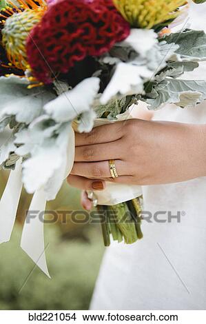 Picture - Close up of bride wearing wedding rings. Fotosearch