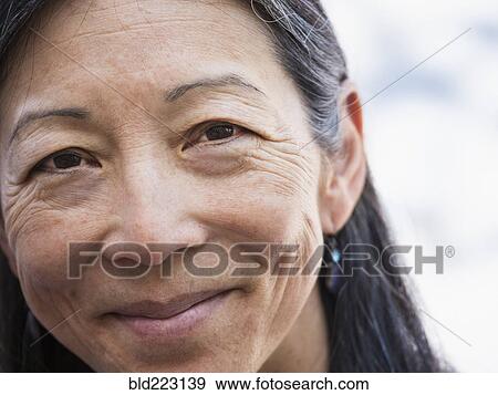 Stock Photo - Close up of face of smiling Japanese woman. Fotosearch