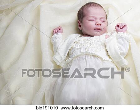 Close up of mixed race newborn baby in christening gown View Large Photo Image Stock Image - Close up of mixed race newborn baby in christening gown. Fotosearch