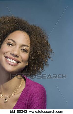 Stock Image - Close up of Mixed Race woman smiling. Fotosearch