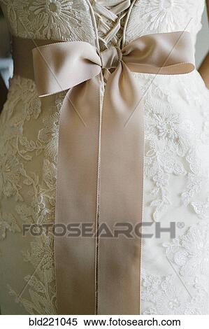 Stock Photography - Close up of sash on wedding dress. Fotosearch