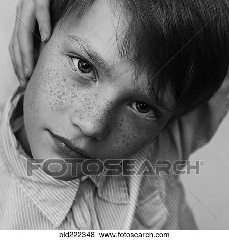 Close up of serious Caucasian boy with freckles View Large Photo Image Stock Photo - Close up of serious Caucasian boy with freckles. Fotosearch