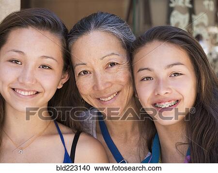 Close up of smiling Asian mother and daughters View Large Photo Image Stock Image - Close up of smiling Asian mother and daughters. Fotosearch