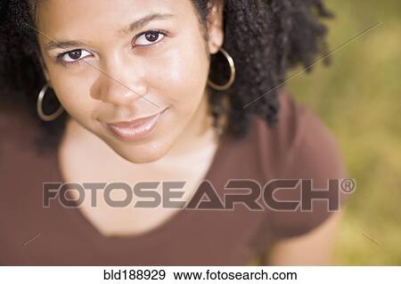 Stock Photo - Close up of smiling mixed race woman. Fotosearch