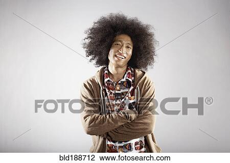 Confident mixed race man with arms crossed View Large Photo Image Stock Image - Confident mixed race man with arms crossed. Fotosearch