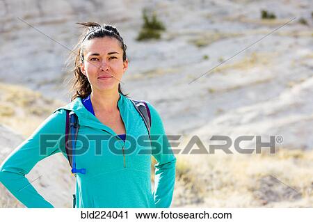 Confident woman standing in canyon wearing backpack View Large Photo Image Stock Image - Confident woman standing in canyon wearing backpack. Fotosearch
