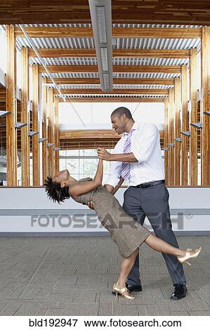 Stock Photo - Couple dancing in empty office space. Fotosearch