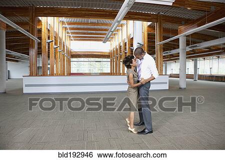 Stock Photograph - Couple dancing in empty office space. Fotosearch