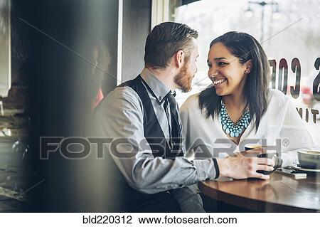 Stock Image - Couple drinking coffee in cafe. Fotosearch