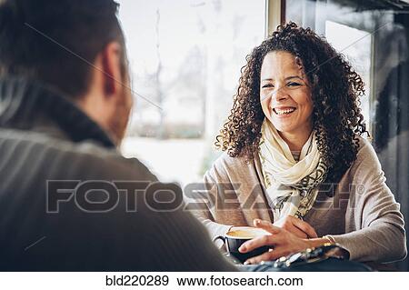 Stock Photo - Couple drinking coffee in cafe. Fotosearch