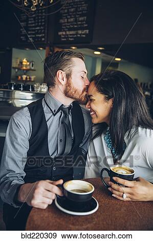 Stock Photo - Couple drinking coffee in cafe. Fotosearch