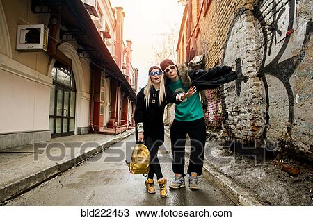 Stock Image - Couple gesturing stop in urban alley. Fotosearch