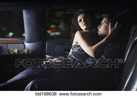 Stock Photo - Couple hugging in backseat of limousine. Fotosearch