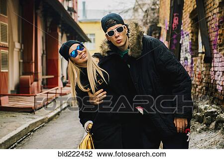 Stock Image - Couple hugging in urban alley. Fotosearch