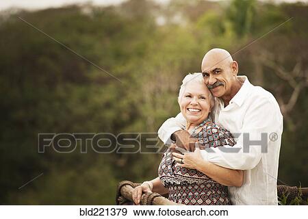 Couple hugging on balcony View Large Photo Image Stock Photo - Couple hugging on balcony. Fotosearch