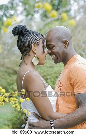 Stock Image - Couple hugging outdoors. Fotosearch