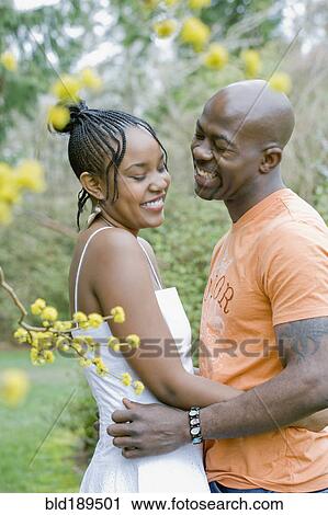 Stock Image - Couple hugging outdoors. Fotosearch