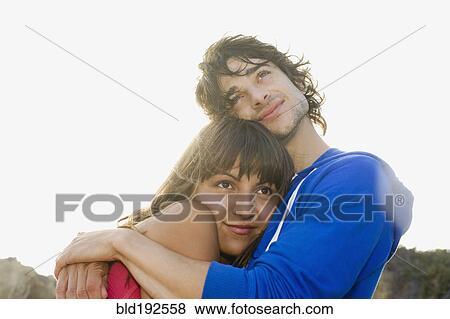 Stock Photo - Couple hugging outdoors. Fotosearch