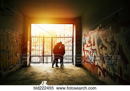 Couple kissing near graffiti at urban gate View Large Photo Image Stock Photography - Couple kissing near graffiti at urban gate. Fotosearch