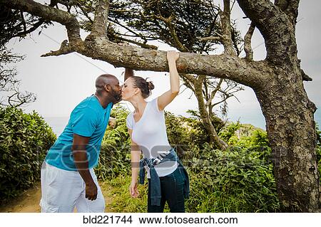 Picture - Couple kissing on path. Fotosearch